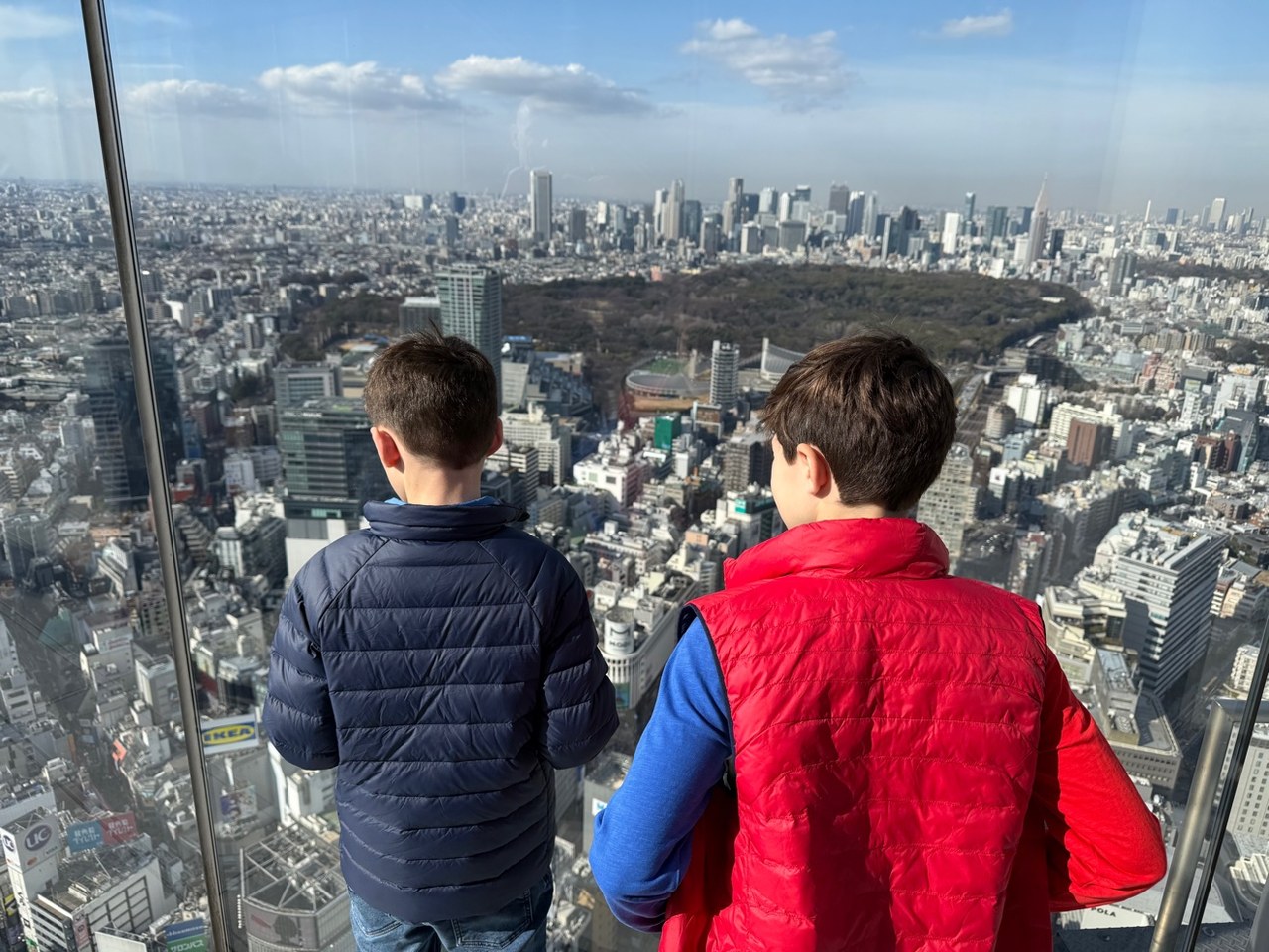 Deux garçons de dos, regardant Tokyo depuis un belvédère en hauteur